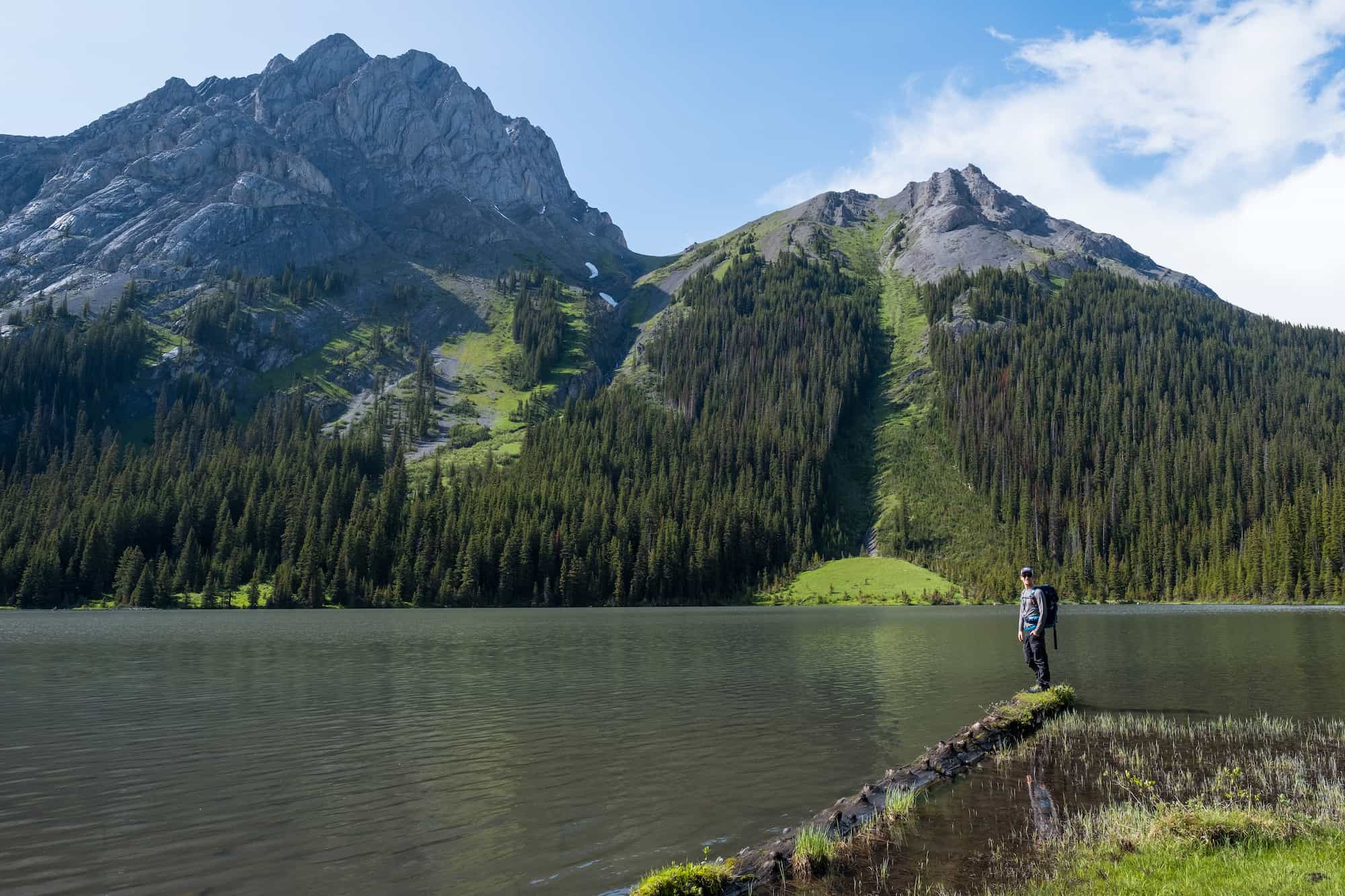 Cameron Stands On A Log By Mud Lake On The Way To Bustall Pass