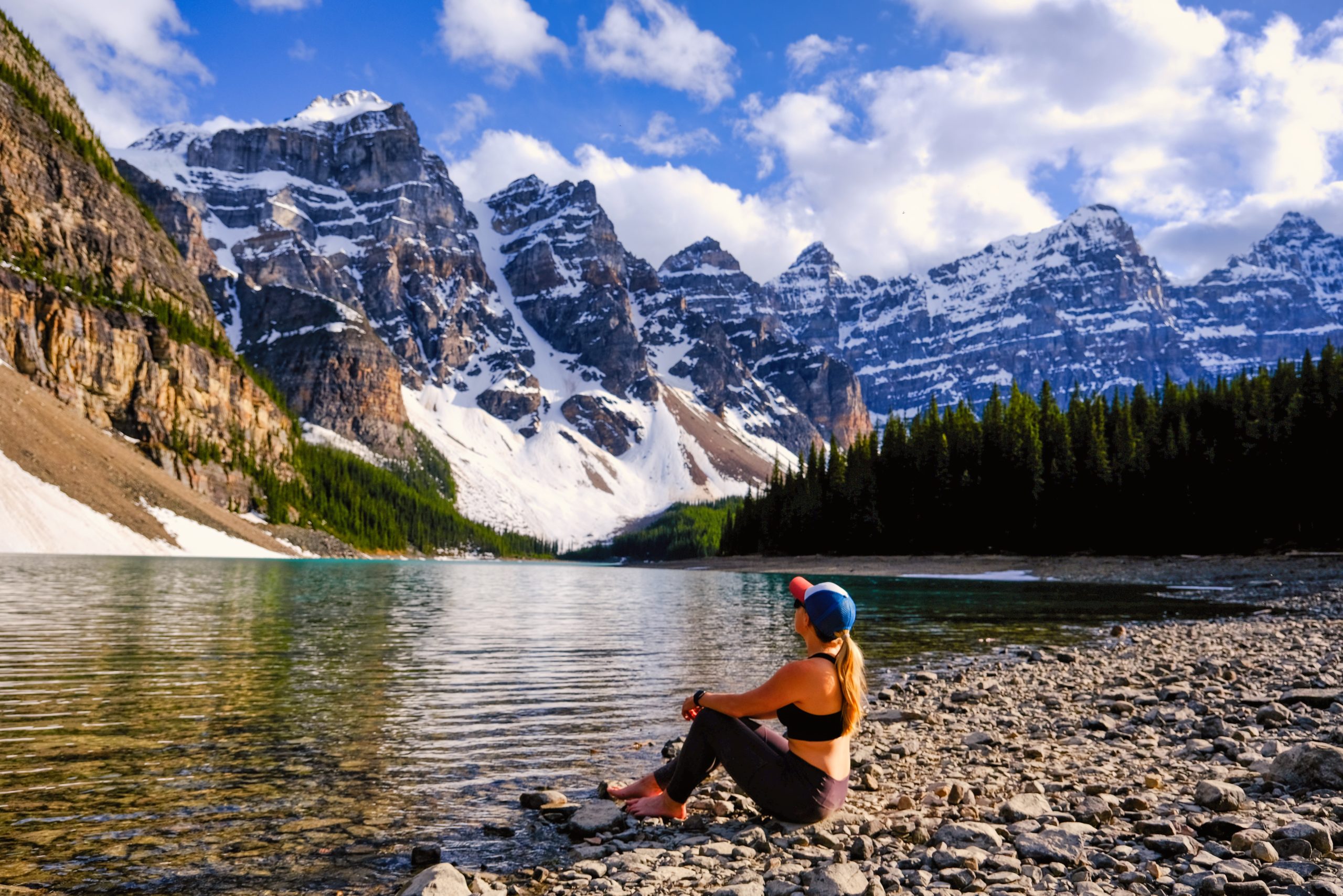 Natasha sitting on the shores of Moraine Lake in June