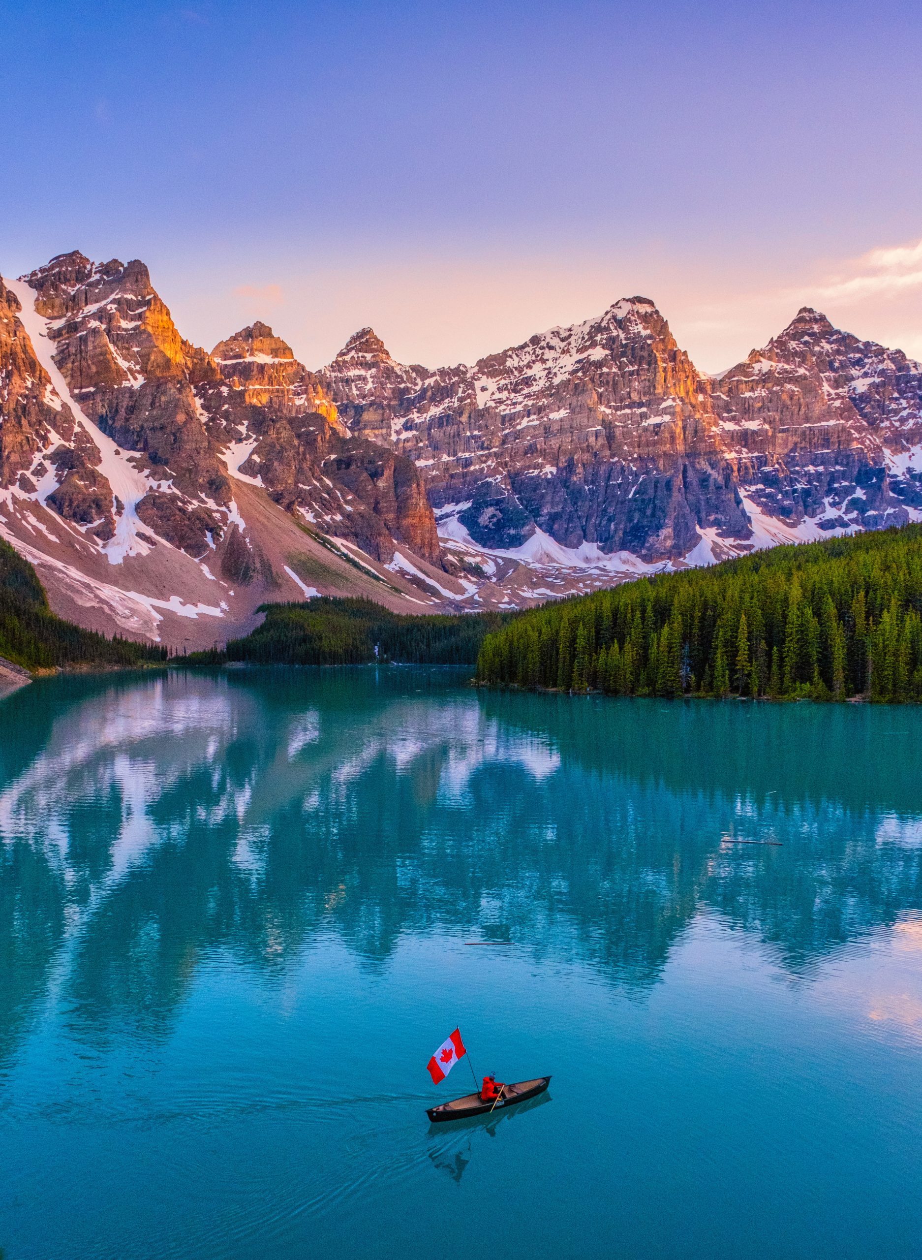 cameron canoeing on moraine lake with canadian flad