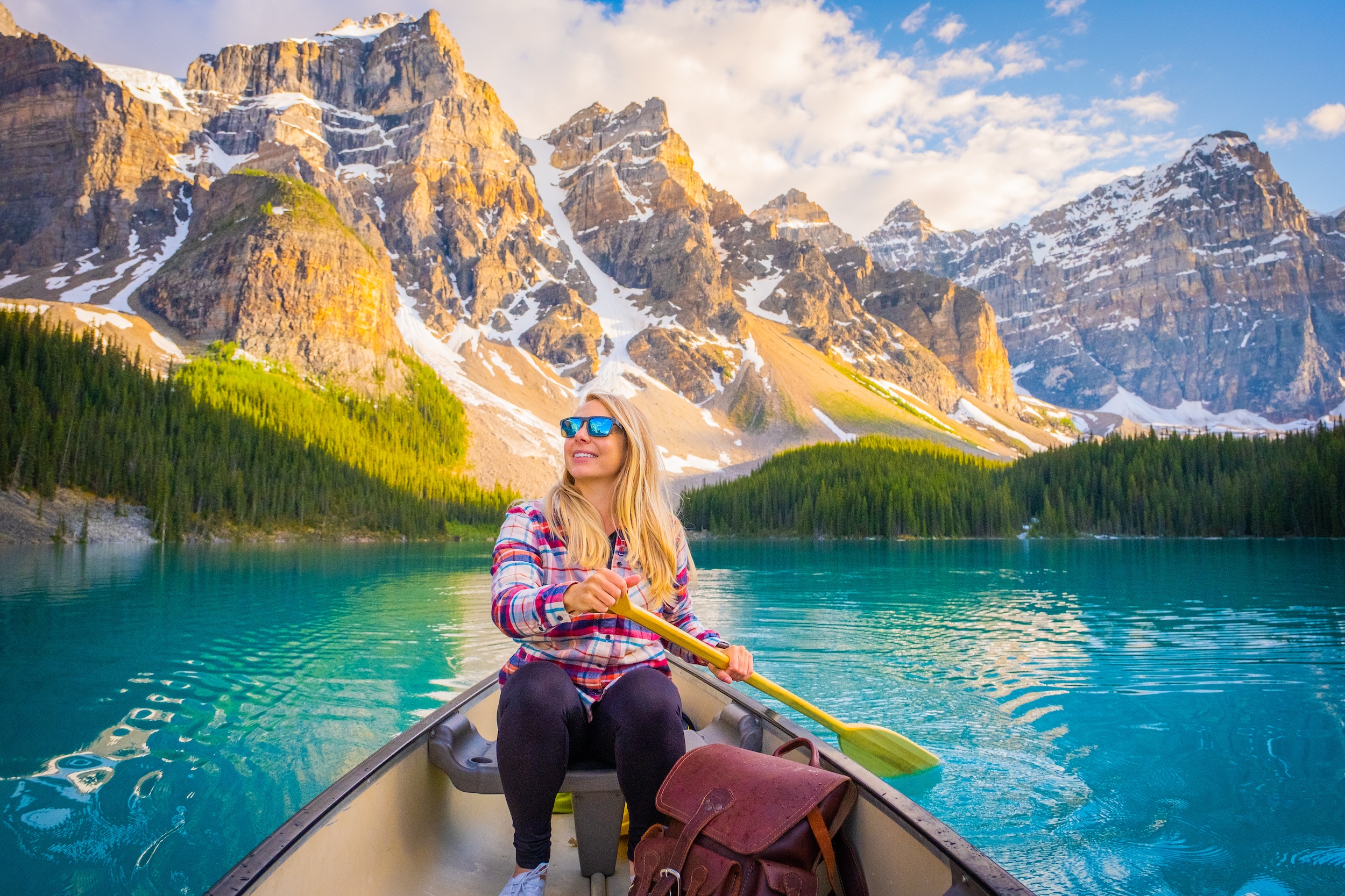 Natasha paddles a canoe on Moraine Lake in the summer