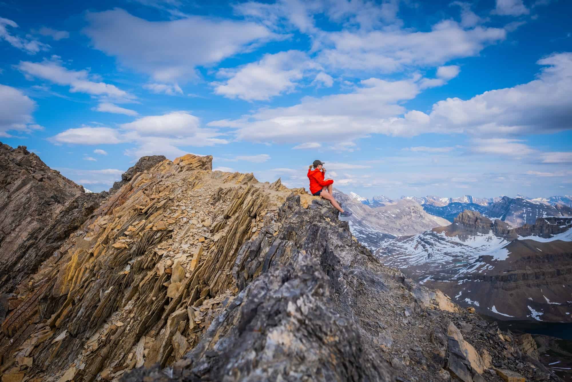 Natasha Sits On Top Of Cirque Peak In Shorts