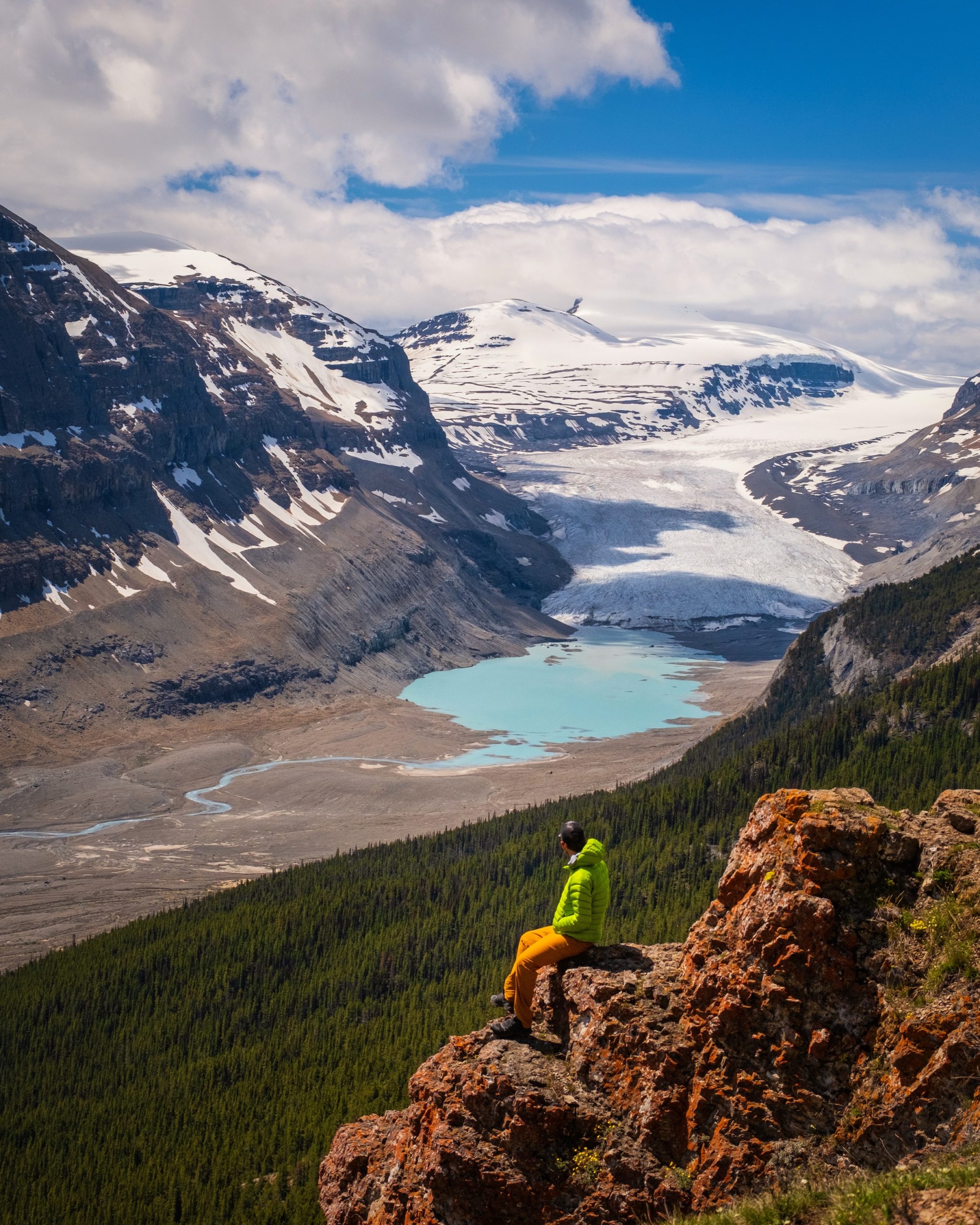 Cameron Sits On Parker Ridge With View Out To Saskatchewan Glacier