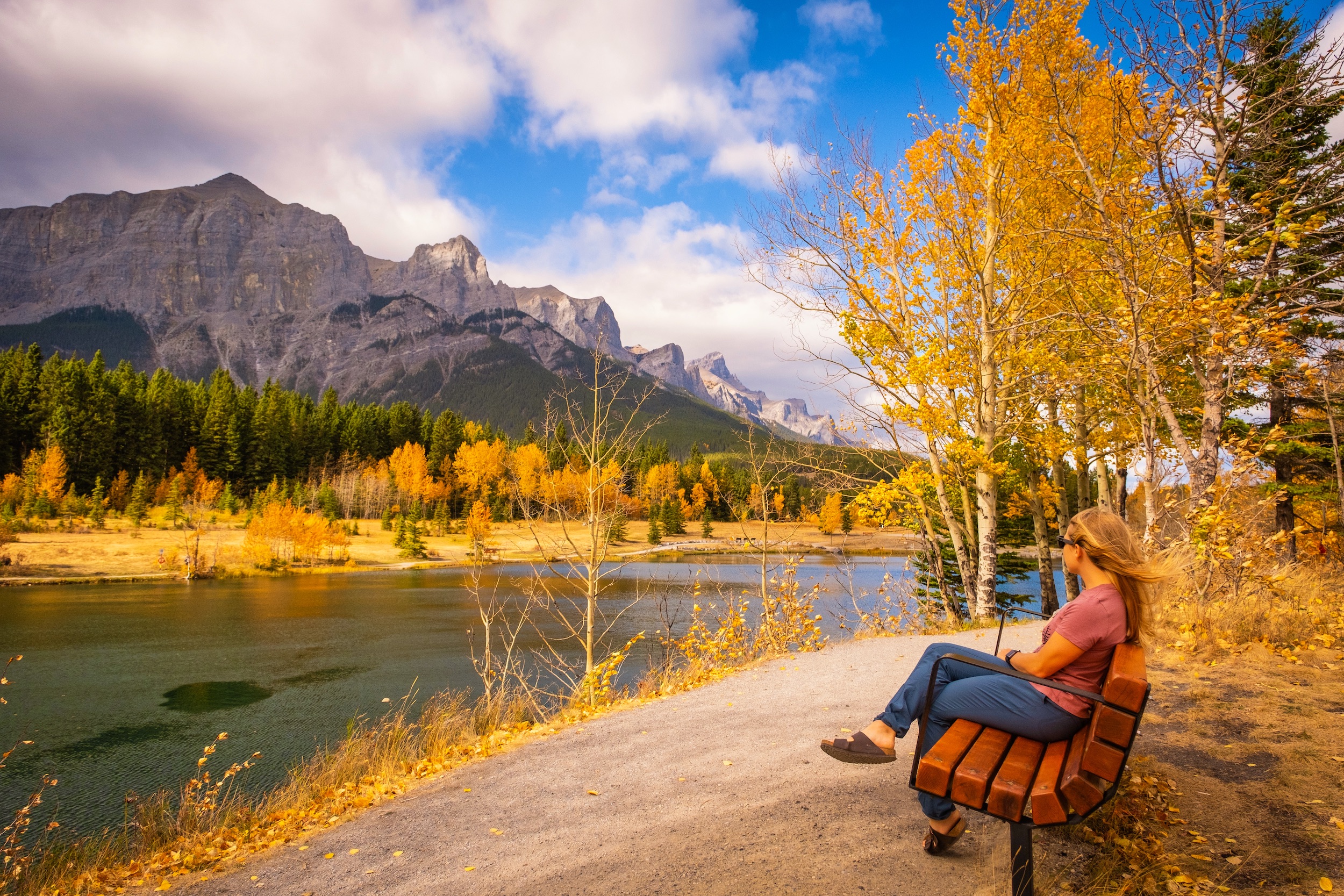 Natasha Sits On A Bench At Quarry Lake In Fall