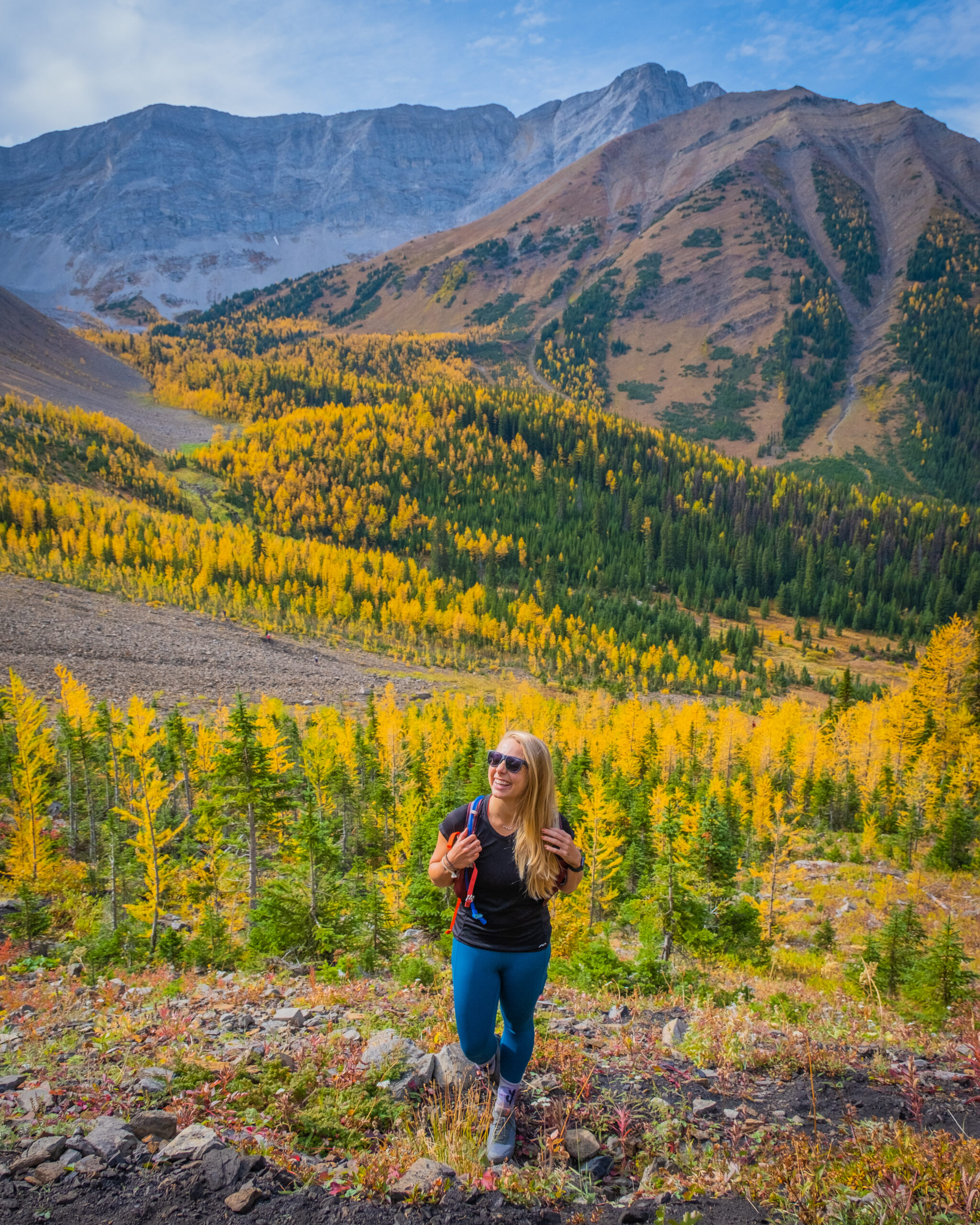 Natasha Ascends Pocaterra Ridge Trail With Larch Trees Behind