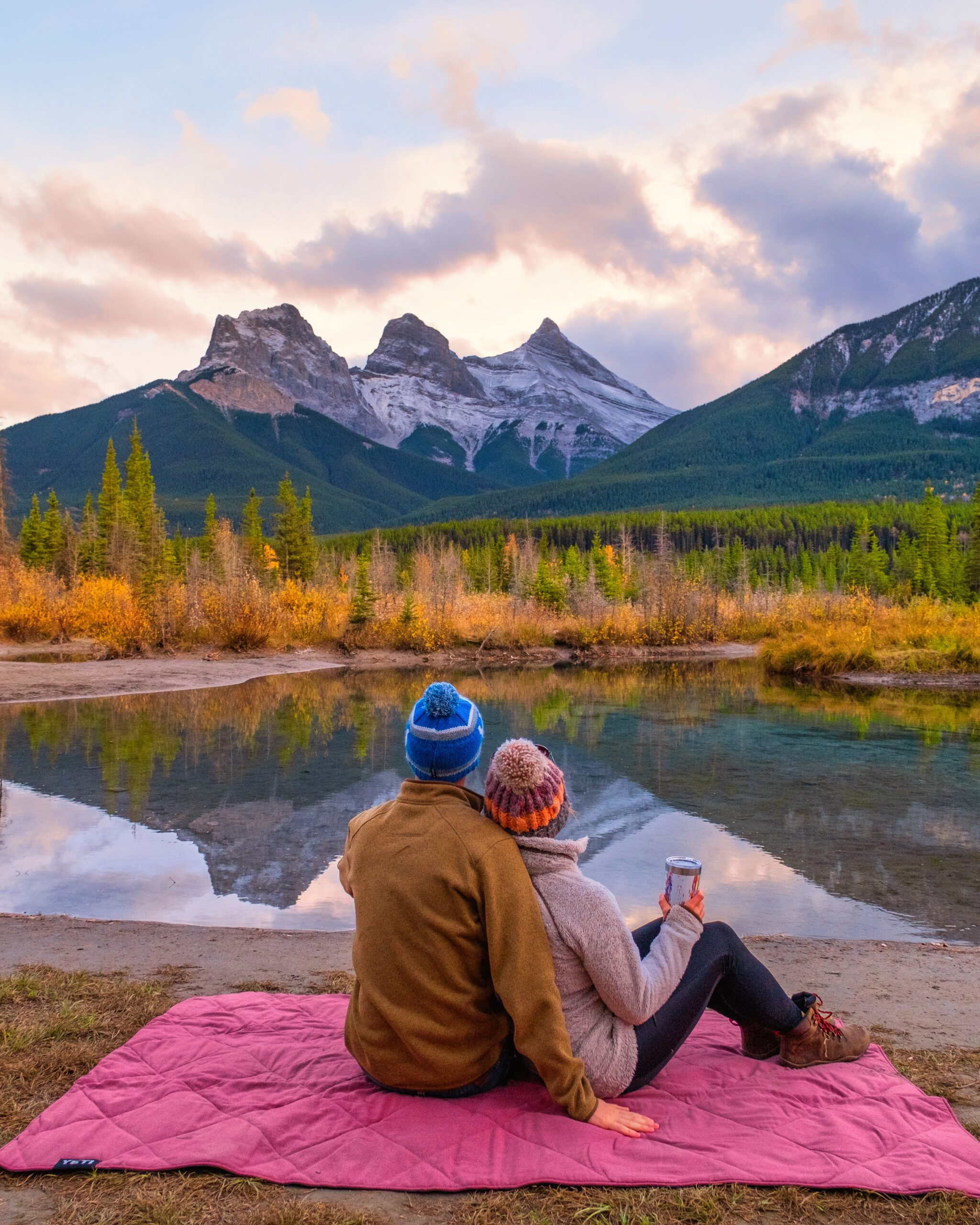 Cameron and Natasha Sit On A Blanket At The Three Sisters Viewpoint