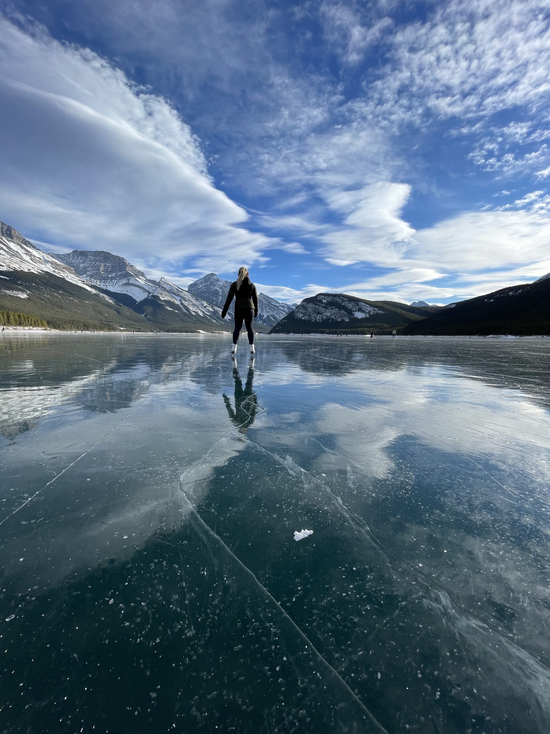 Natasha Skating on Spray Lakes Reservoir in Kananaskis Country on a sunny day