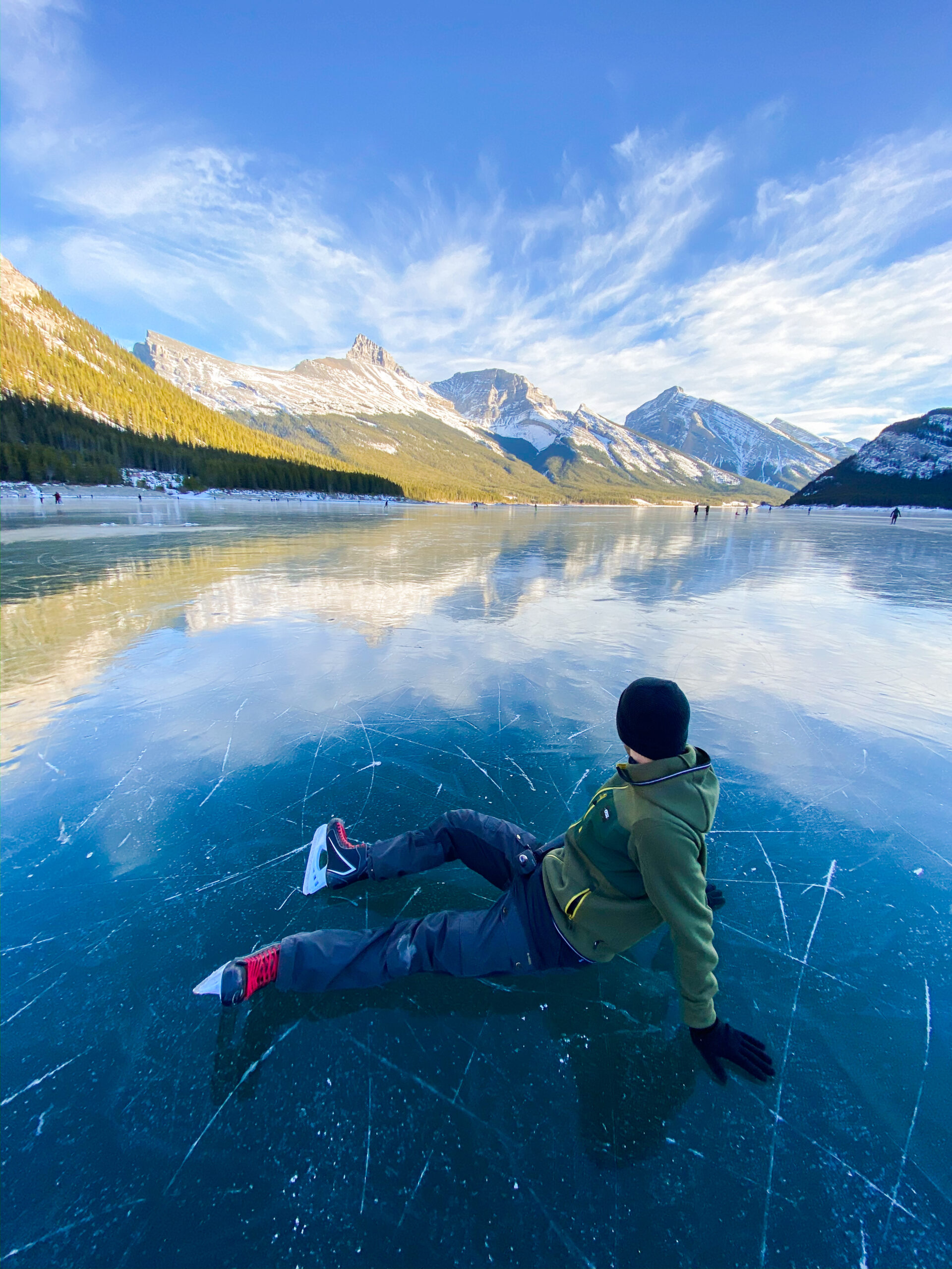 Cameron Sits Down On A Frozen Spray Lakes With Ice Skates