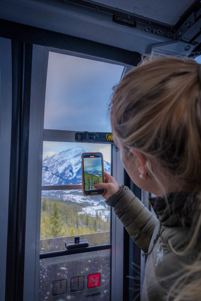 Taking A Photo out the Banff Gondola Cabin