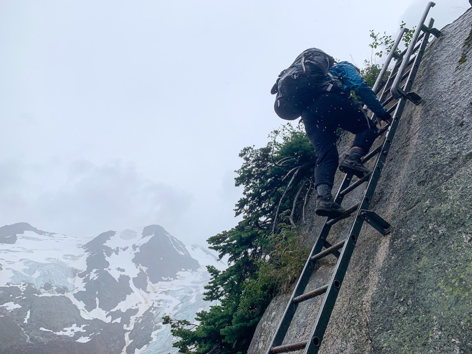 Using the ladder in the rain on the hike down