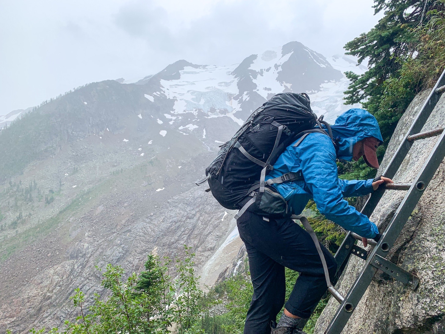 Using the ladder in the rain on the hike down