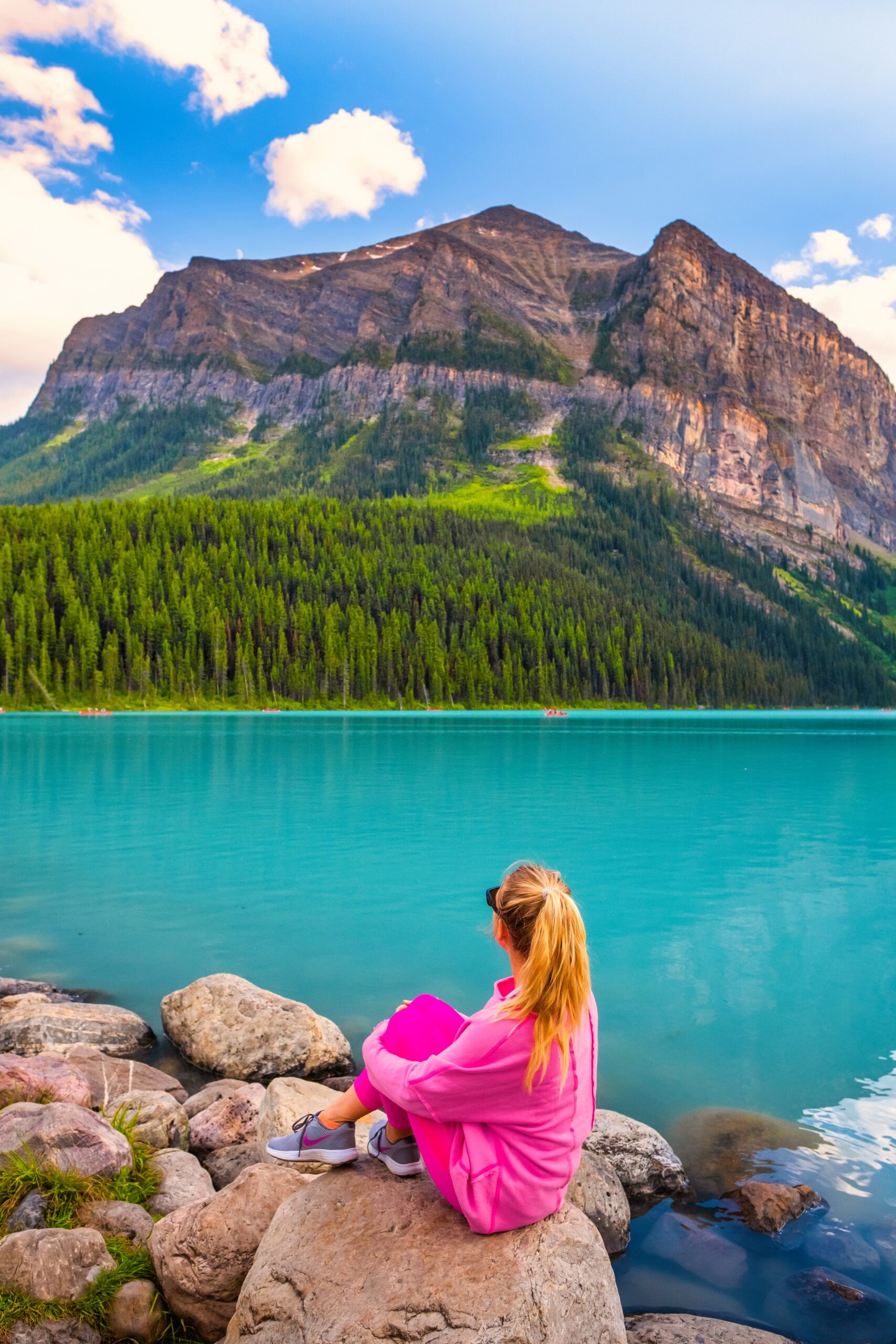 Natasha Sits Along The Lake Louise Lakeshore In Pink