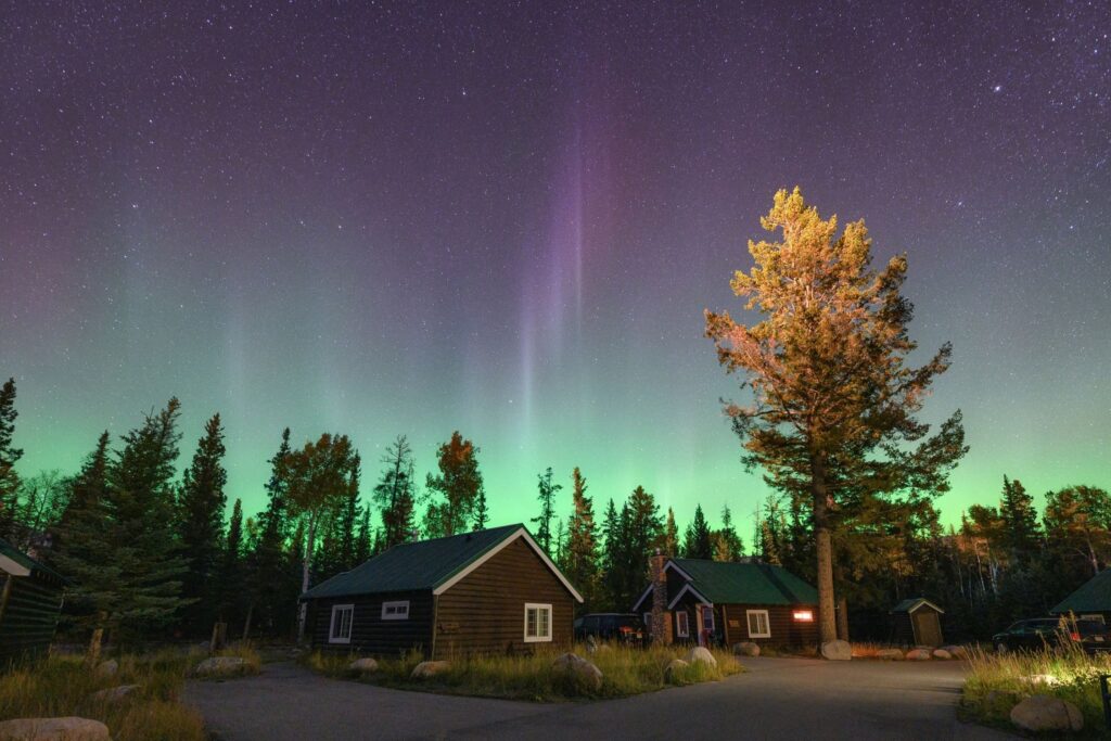 The Northern Lights over cabins in Jasper