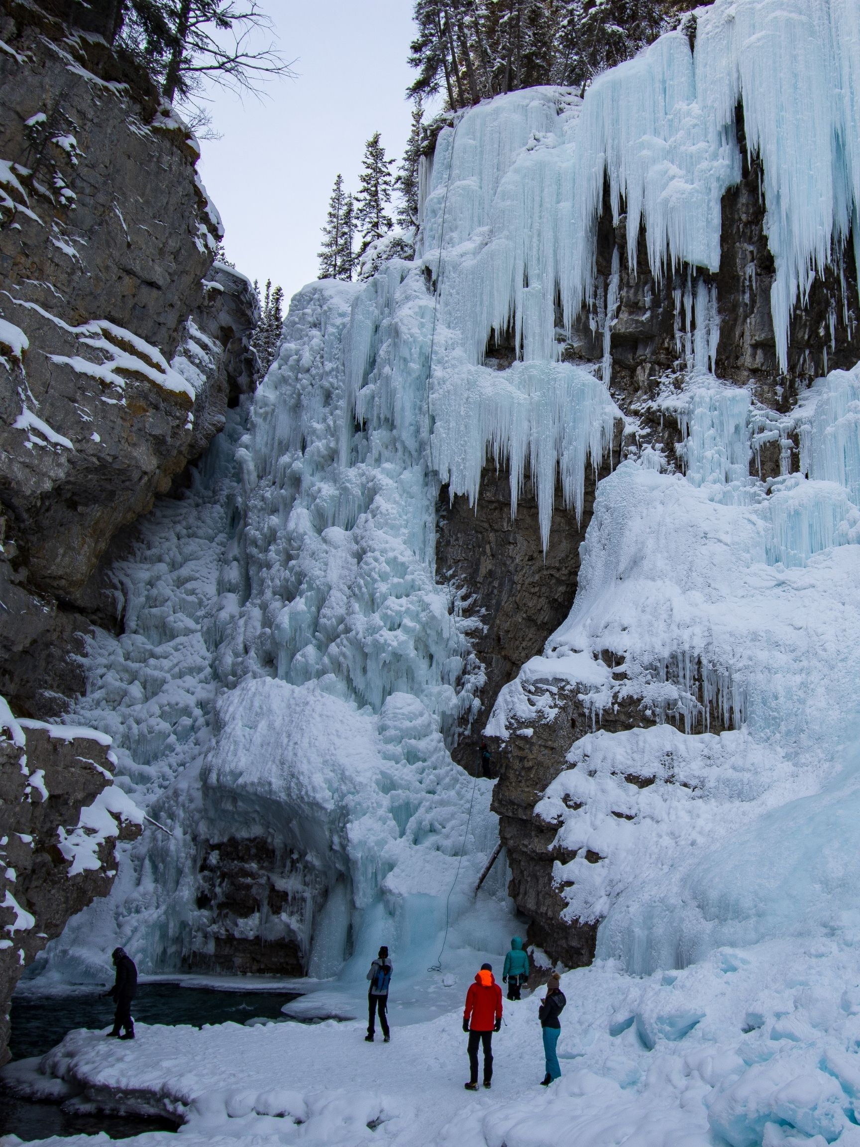 Standing At The Base Of Frozen Waterfall Johnston Canyon