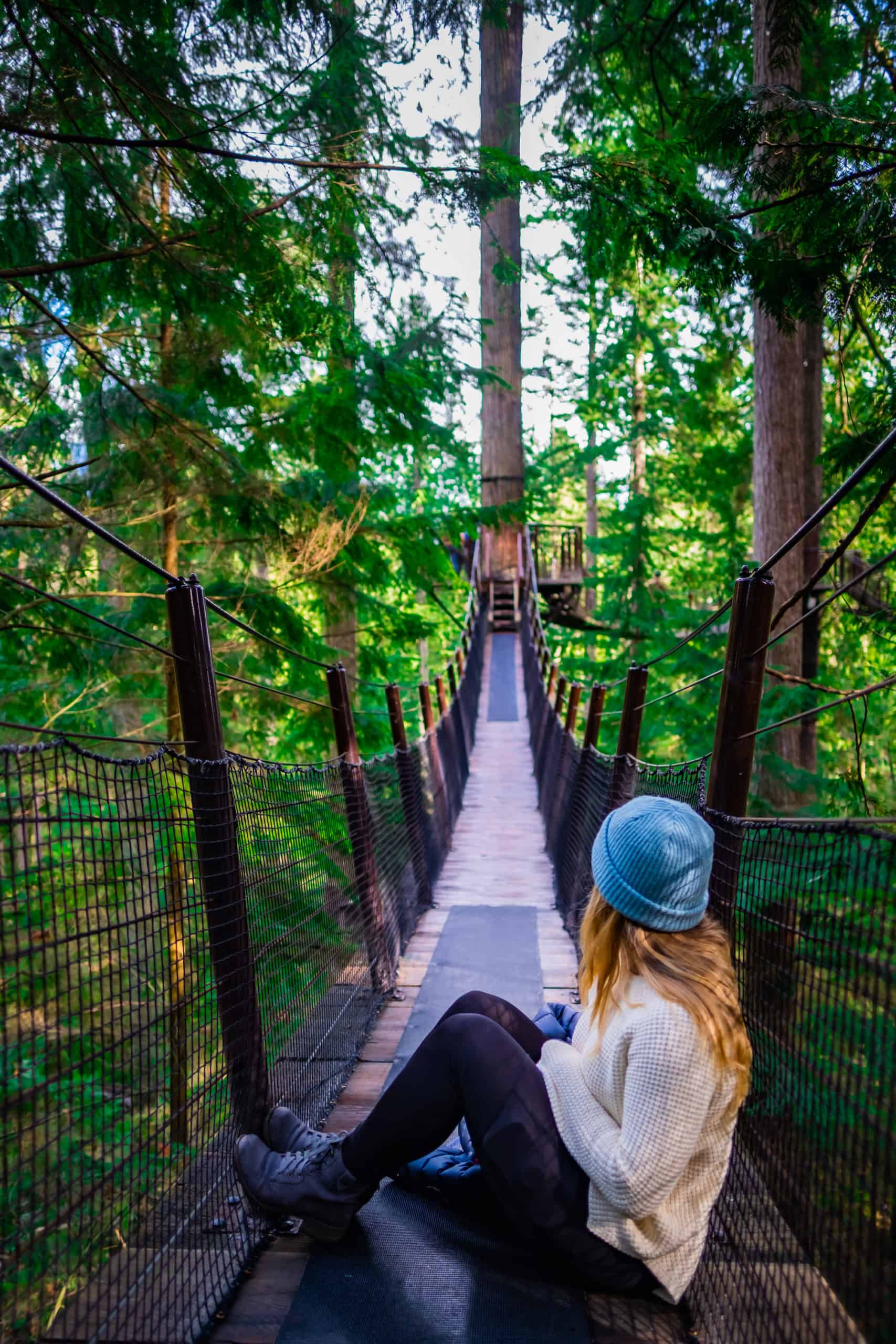 Natasha sitting on the Capilano Suspension Bridge