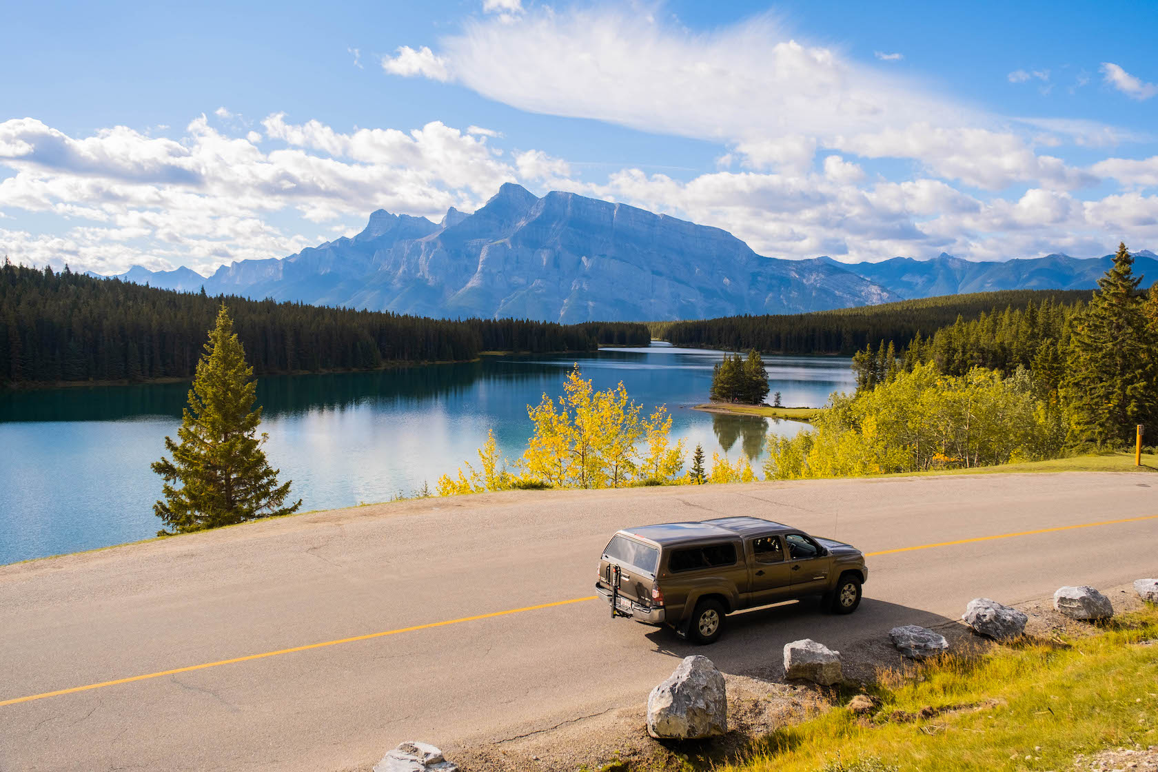 Our Truck Drives Along Two Jack In The Fall With Mount Rundle In The Background