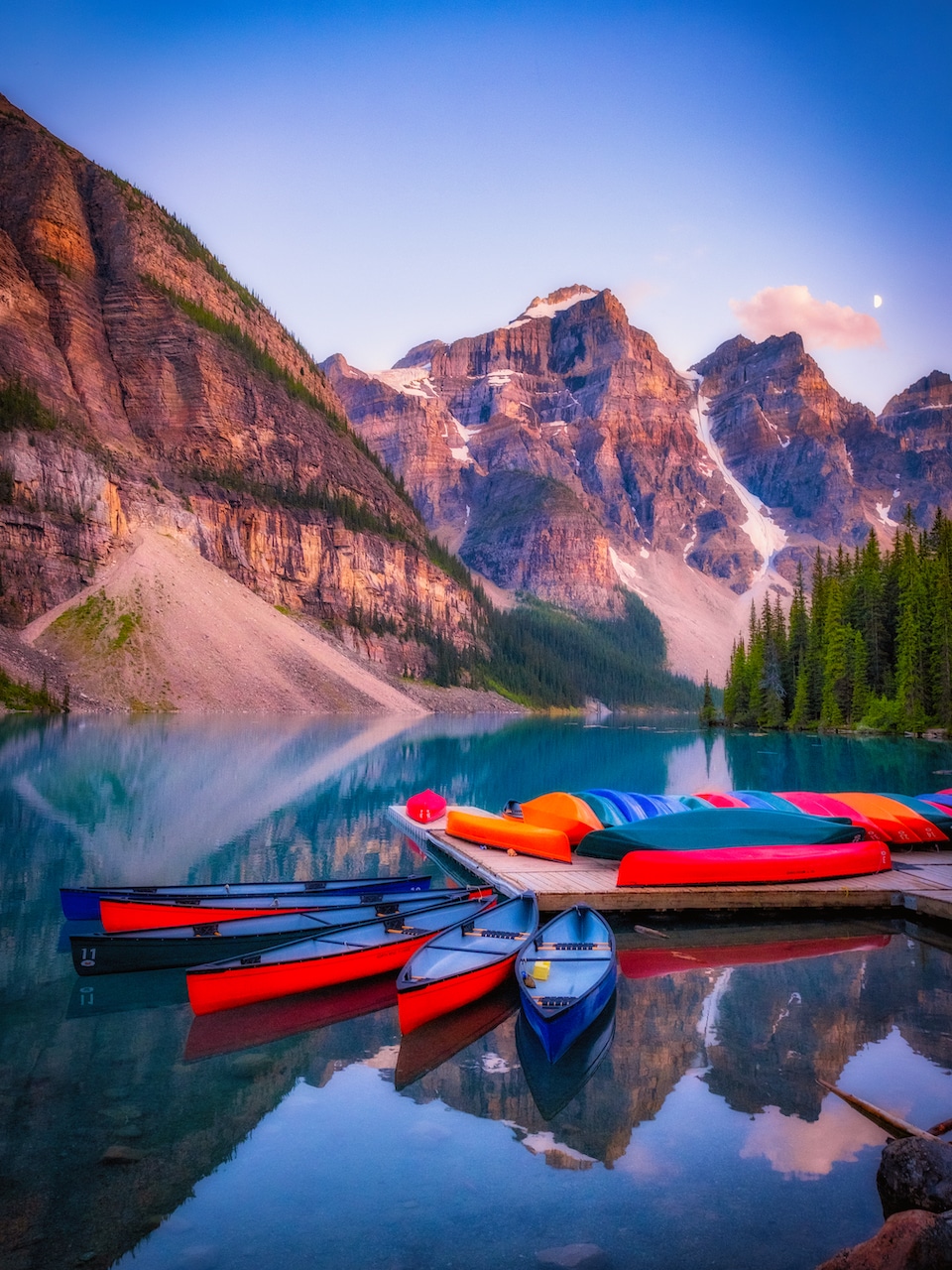 Canoes Sitting On Moraine Lake