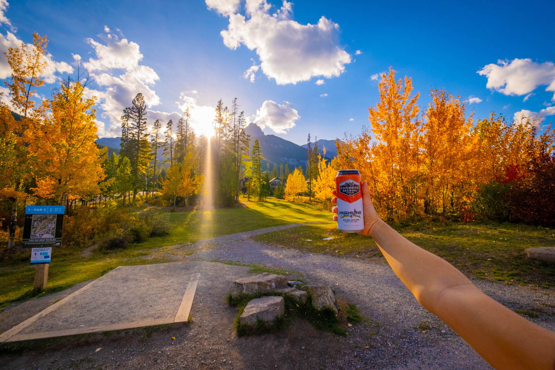 Natasha Holds A Beer Up At The Canmore Disc Golf Course In Three Sisters