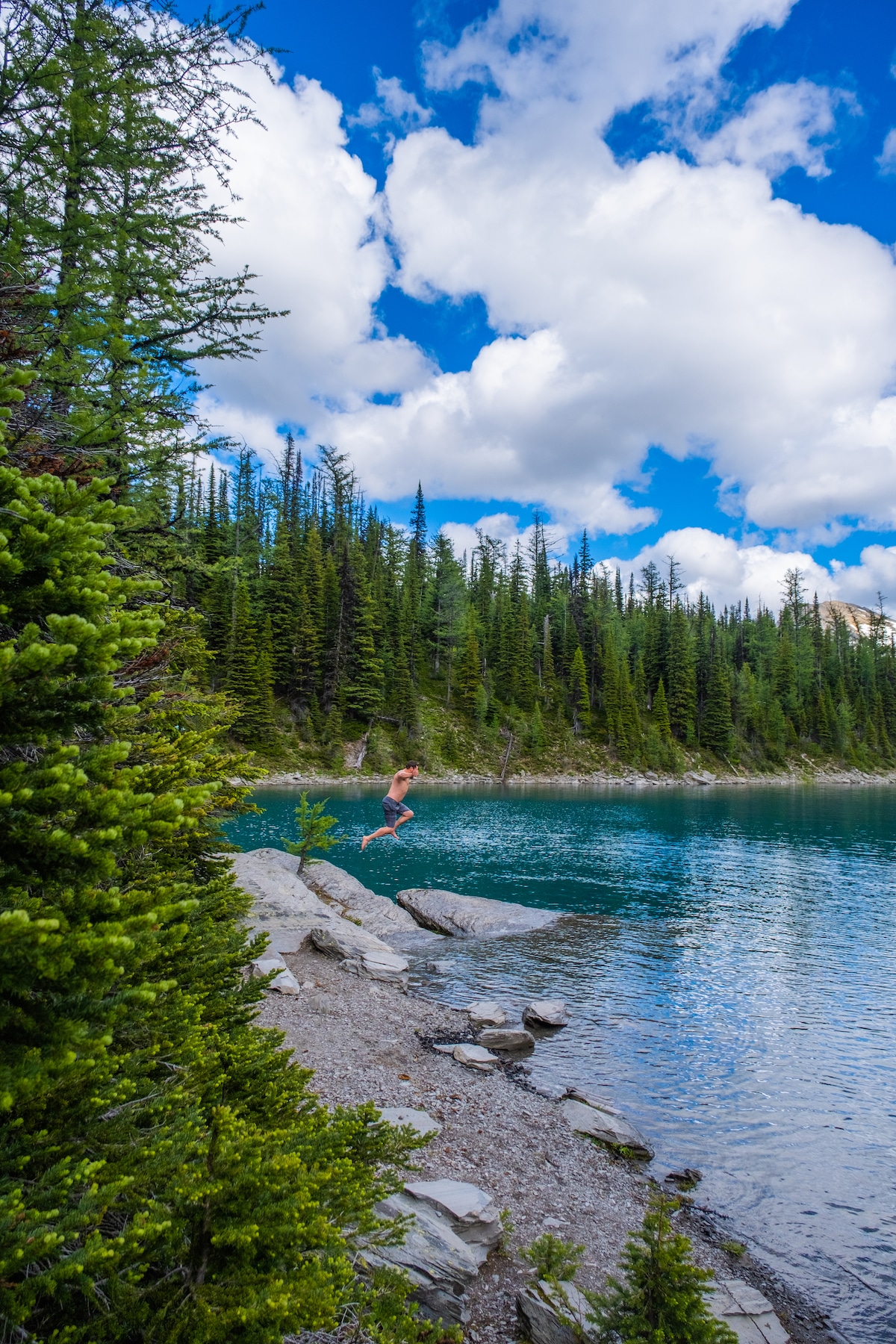 hiker jumping into floe lake