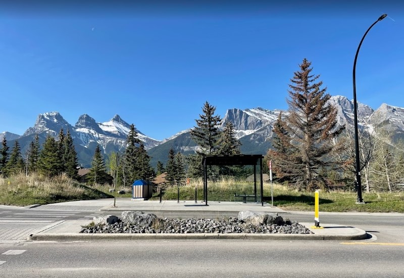 Bus stop in Canmore with Three Sisters Mountain in the background