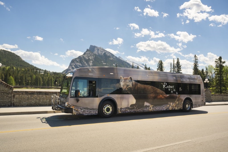 Roam Transit bus in Banff by Rundle Mountain