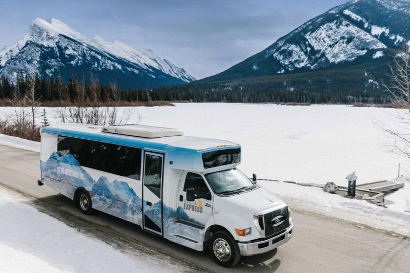 Brewster express bus by Vermillion lakes in Banff National Park