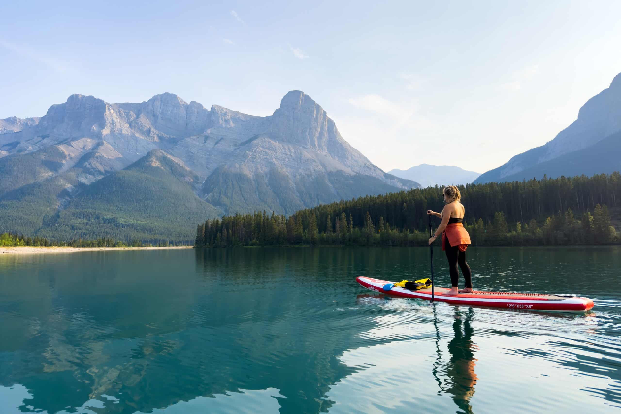 Natasah Paddles Along The Canmore Resevoir In The Evening