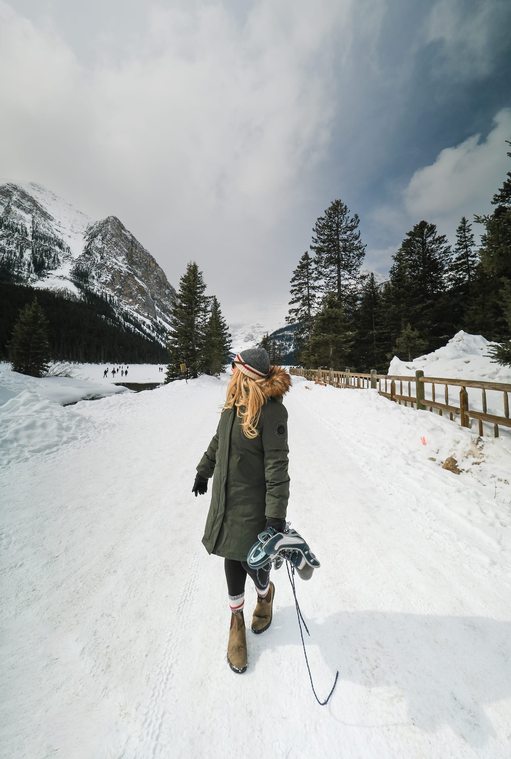 Natasha Carries A Pair Of Ice Skates From At Lake Louise In April