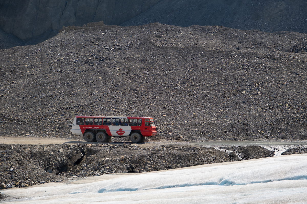 An Ice Explorer Vehicle Drives Over A Rock Moraine