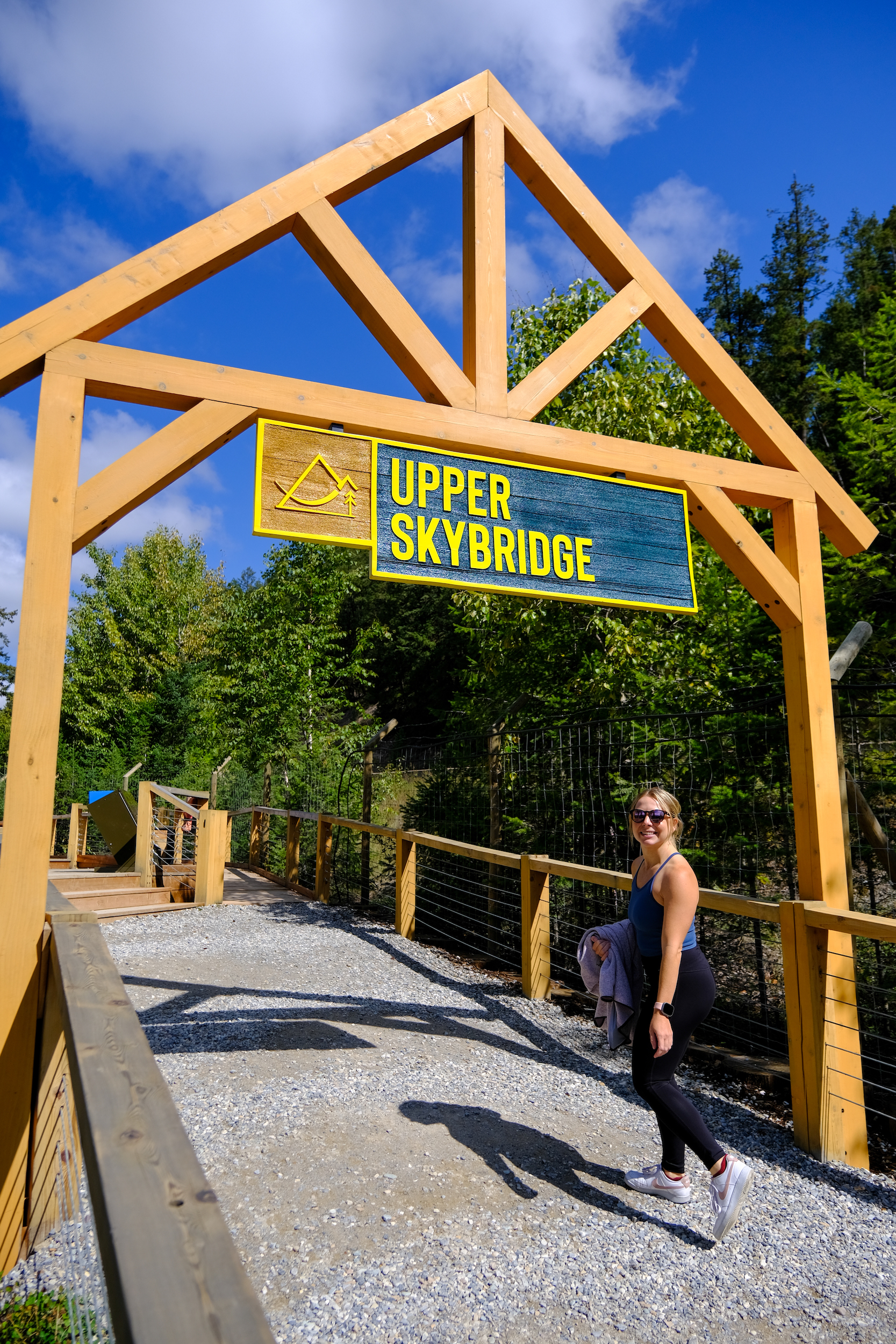 Natasha Standing By Golden Skybridge Upper Suspension Sign