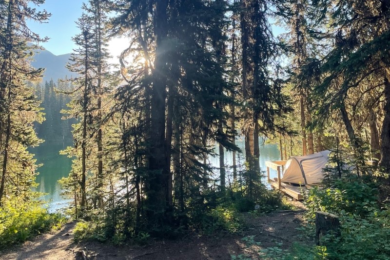 Sun rise at Lillian Lake campground with tent overlooking the waters