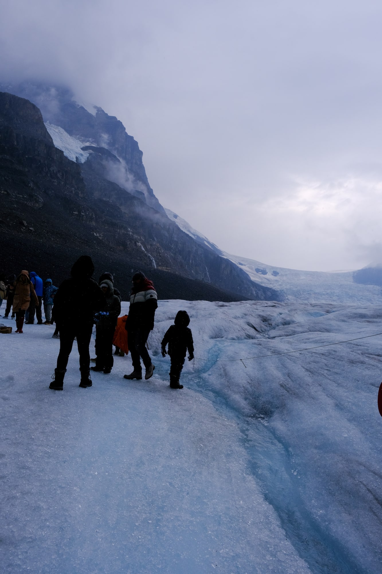 A Family Stands On Athabasca Glacier