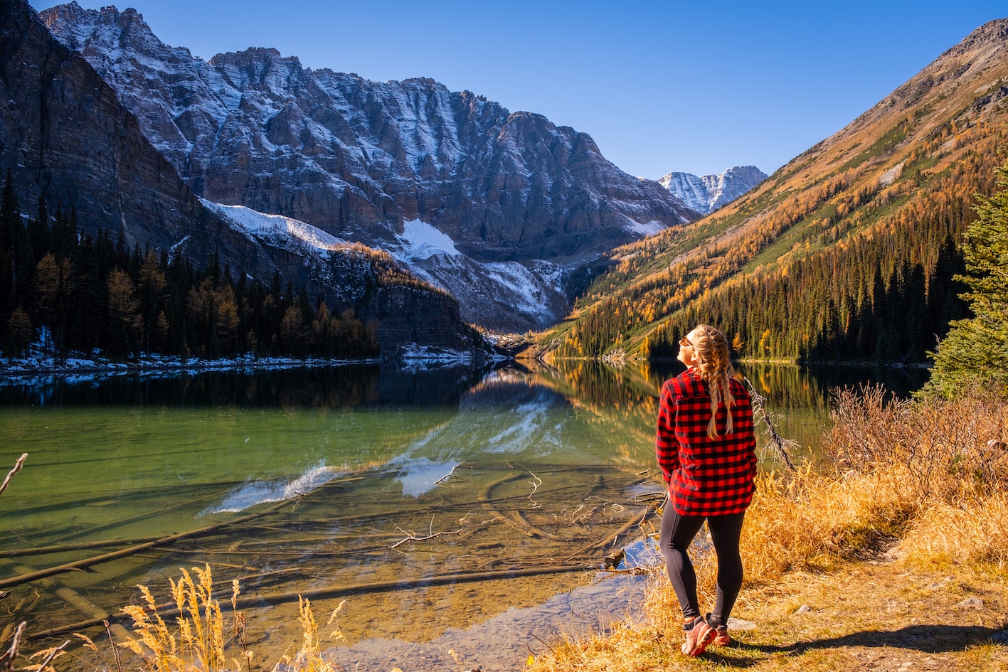 Natasha Stands Next To Taylor Lake In Flannel during larch season